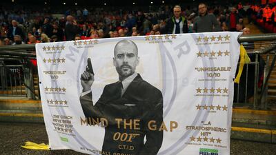 A banner bearing a picture of Pep Guardiola dressed as James Bond. Catherine Ivill / Getty Images