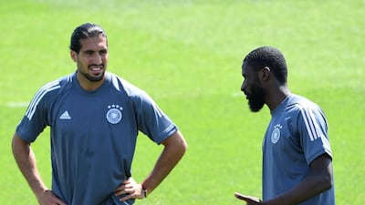 Germany's Emre Can, left, speaks with fellow defender Antonio Rudiger. AFP