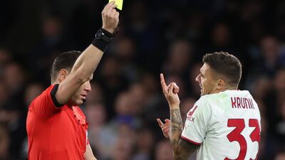 Referee Danny Makkelie shows a yellow card to Milan's Rade Krunic in the first-half. EPA
