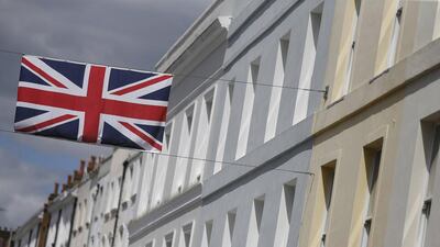 A Union flag hangs across a street of houses in London. British house prices in parts of the country have increased significantly in recent years (REUTERS/Suzanne Plunkett)
