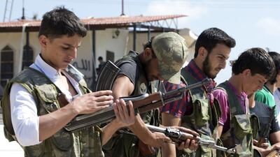Volunteers for the Amr Ibn Al Aass brigade load their rifles during training on the outskirts of Azaz, in northern Syria. Miguel Medina / AFP