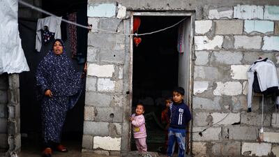 A Palestinian woman with her children at their house in Khan Younis in the southern Gaza Strip. Reuters