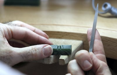 Carving the grooves for a ballerina's skirt using a file and wax. Pawan Singh / The National