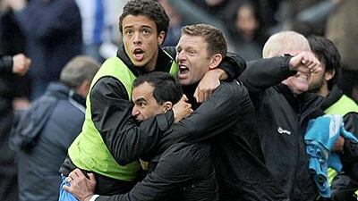 Roberto Martinez, centre, is mobbed by the Wigan bench following Charles N’Zogbia’s late winner against West Ham United at the DW Stadium last week that gives them a fighting chance of survival.