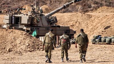 Israeli soldiers near a self-propelled howitzer near the border with Gaza in southern Israel. AFP