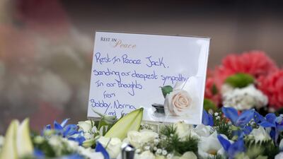 Floral tributes and messages of condolence are pictured as the funeral cortege of British football legend Jack Charlton arrives at the West Road Crematorium. AFP