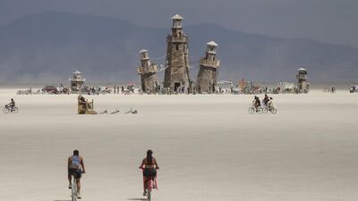 The Black Rock Lighthouse Service installation is shown in the distance during Burning Man at the Black Rock Desert near Gerlach, Nevada. Chase Stevens / Las Vegas Review-Journal via AP