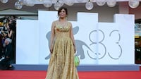 Jury member Kaouther Ben Hania wears an all-gold gown by Tunisian label Nee A Tunis at Venice Film Festival’s opening ceremony. AFP