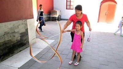 Zhou Lirong, 39, with her six-year-old daughter, Dou Rui. They are from Beijing.