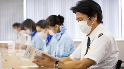 Pilots and cabin crew from All Nippon Airways receive the Moderna coronavirus vaccine at Haneda Airport, Tokyo, Japan. Getty Images