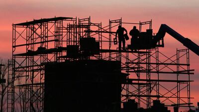 A construction crew erects scaffolding at sunset on a new housing project in Silver Spring, Maryland. Gary Cameron / Reuters