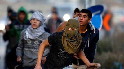 Palestinians clash with Israeli troops following a protest against US president Donald Trump's decision to recognise Jerusalem as the capital of Israel, in the West Bank city of Nablus on December 12, 2017. Majdi Mohammed / AP