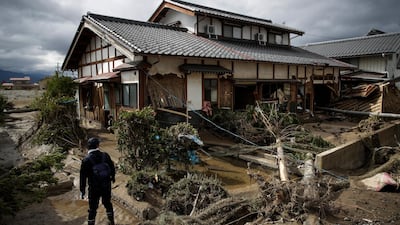 A man surveys a home damaged by Typhoon Hagibis in Nagano, Japan. More victims and more damage have been found in typhoon-hit areas of central and northern Japan, where rescue crews are searching for people still missing. AP Photo