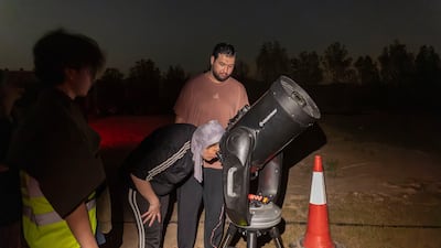 Visitors enjoy the observations in a dedicated area with telescopes set up to view the event. Antonie Robertson/The National