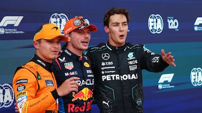 Max Verstappen celebrates after qualifying in pole position with second-placed Lando Norris of McLaren and third-placed George Russell of Mercedes. Reuters