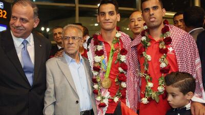 Jordan’s Prince Faisal bin Al Hussein, left, with Ahmed Abughaush, centre. Khalil Mazraawi / AFP