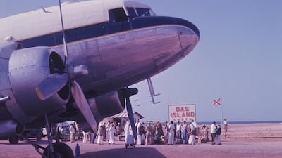 A Douglas DC-3 operated by Gulf Aviation at Das Island airport in 1962. The flag carries the emblems of British Petroleum and Abu Dhabi Marine Areas.