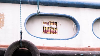 Boxes of ketchup are loaded onto a dhow at Dubai Creek. Reem Mohammed / The National