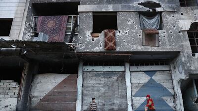 Syrian children play next to a destroyed building in the rebel-held town of Douma, on the eastern outskirts of the capital Damascus. Abd Doumany / AFP