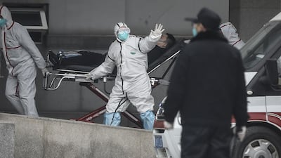 Medical staff transfer patients to Jin Yintan hospital in Wuhan, Hubei, China. Getty Images