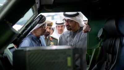 The President and Sheikh Mansour view the interior of a vehicle during a tour of the exhibition