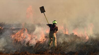 Firefighters tackle a blaze on moorland above Marsden. AFP