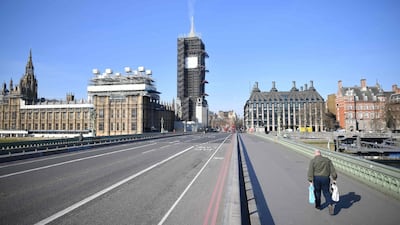 A picture shows the Houses of Parliament at the end of an empty Westminster Bridge in central London, the morning after Britain ordered a lockdown to slow the spread of the novel coronavirus. AFP