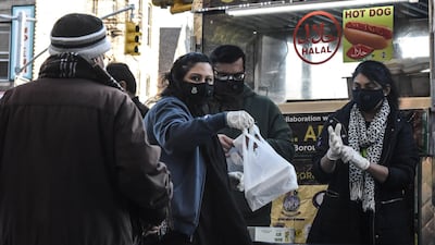 Members of the Pakistani Youth Society distribute free meals in the Flatbush neighbourhood of Brooklyn in New York City. AFP
