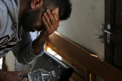 Hawye Rasool Saleh, 32, a migrant from Iraq washes his face at his living space under a hotel in central Nicosia, Cyprus. AP