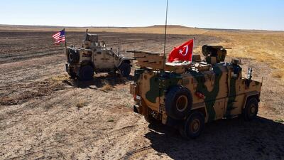 Turkish and US military vehicles on patrol along the Syrian-Turkish border near Tel Abyad, Syria. Reuters