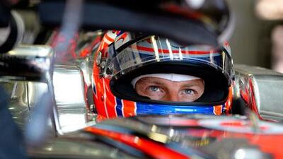 F1 driver Jenson Button sits in his car during the first practice session at Monte Carlo
