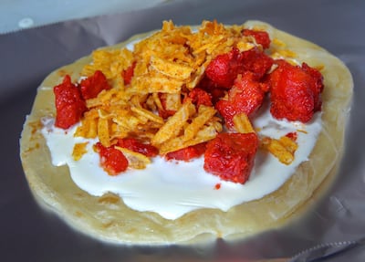 Chicken, cheese and Chips Oman make for a winning combination, especially when wrapped within a parotta. This dish is from Rashid Ali Hassan Cafeteria in Abu Dhabi. Victor Besa / The National