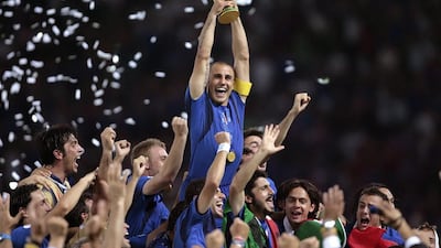 Italian defender Fabio Cannavaro, centre, celebrates with the trophy after his team won the 2006 World Cup final against France on July 9, 2006, at the Olympic Stadium in Berlin. Pascal Pavani / AFP