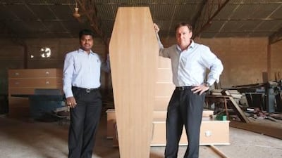 Mahadeer Mohamed and Vivian Albertyn of the funeral services company Middle East Assistance with a "European-style repatriation coffin" made in Sharjah. They pursued but did not win the Dubai Health Authority's contract to supply coffins for repatriations.