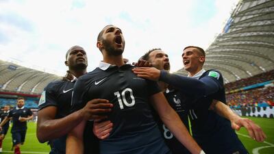 Karim Benzema of France, second from left, celebrates with teammates after scoring his team's first goal on a penalty kick during the 2014 Fifa World Cup Brazil Group E match between France and Honduras at Estadio Beira-Rio on June 15, 2014 in Porto Alegre, Brazil. (Photo by Ian Walton/Getty Images)