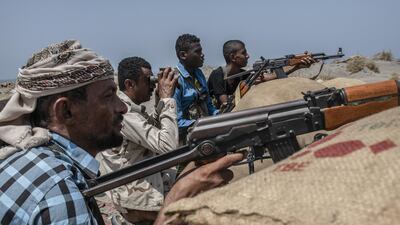 Pro-government fighters look for Houthi rebel positions on a frontline east of Hodeidah port city, Yemen. Getty Images