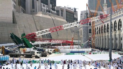 Muslim pilgrims walk past the crane that collapsed the day before at the Grand Mosque in Saudi Arabia's holy Muslim city of Mecca on September 12, 2015. AFP