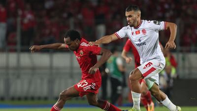 Ahly's South African forward Percy Tau is marked by Wydad's Moroccan midfielder Jalal Daoudi. AFP
