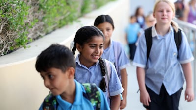 Children returning to the British School Al Khubairat, Abu Dhabi, on Monday. Chris Whiteoak / The National