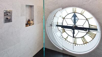 The bathroom’s shower room has as its “window” the back of the clock that oversees the square built in to its external wall. Courtesy Knight Frank
