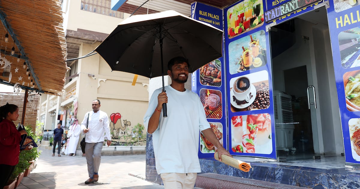A resident takes cover during the summer heat in Dubai. Chris Whiteoak / The National