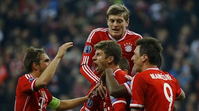 Bayern Munich players Philipp Lahm, Thomas Mueller, Toni Kroos and Mario Mandzukic (left to right) celebrate Mueller's goal to go ahead against Manchester United during their Champions League quarter-final match on Wednesday. Kai Pfaffenbach / Reuters / April 9, 2014