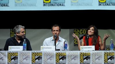 Fro left: Director Alfonso Cuaron, producer David Heyman and actress Sandra Bullock speak onstage at the Warner Bros and Legendary Pictures preview of Gravity during Comic-Con International. Kevin Winter / Getty Images / AFP