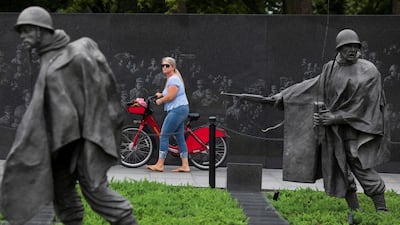 A visitor wheels a bicycle through the newly renovated Korean War Veterans Memorial on the National Mall in Washington. Reuters
