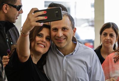 Gibran Bassil, the Lebanese Foreign Minister and leader of the "Free Patriotic Movement", poses for a selfie with his wife Chantal as he arrives to cast his vote at a polling station in the Lebanese coastal city of Batroun, north of the capital Beirut, on May 6, 2018, as the country votes in the first parliamentary election in nine years. Ibrahim Chalchoub / AFP