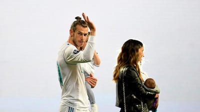 Real Madrid's Welsh forward Gareth Bale waves to fans at the Bernabeu during a victory ceremony after Real Madrid won a third Champions League title in a row in Kiev. Oscar del Pozo / AFP