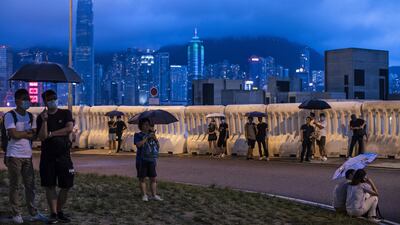Demonstrators stand in front of barricades outside West Kowloon Station, Hong Kong, on Sunday during a protest against a bill to permit extraditions to China. Bloomberg