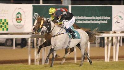 Tadgh O’Shea rides Chase Me, the grey, to victory at Abu Dhabi Equestrian Club last night.