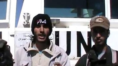 An image from a video uploaded on YouTube on Wednesday allegedly shows Syrian rebels standing in front of a UN vehicle in the Golan Heights. AFP