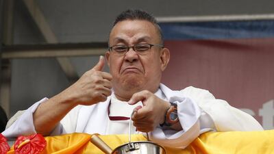 A priest gestures after he ran out of holy water as he prepares for Black Nazarene in Manila. Erik De Castro / Reuters